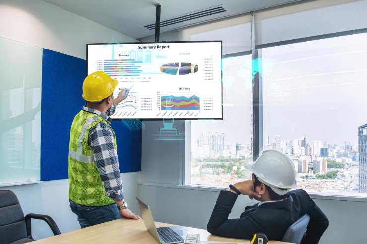 Image showing two construction professionals sitting in an office analysing a project report