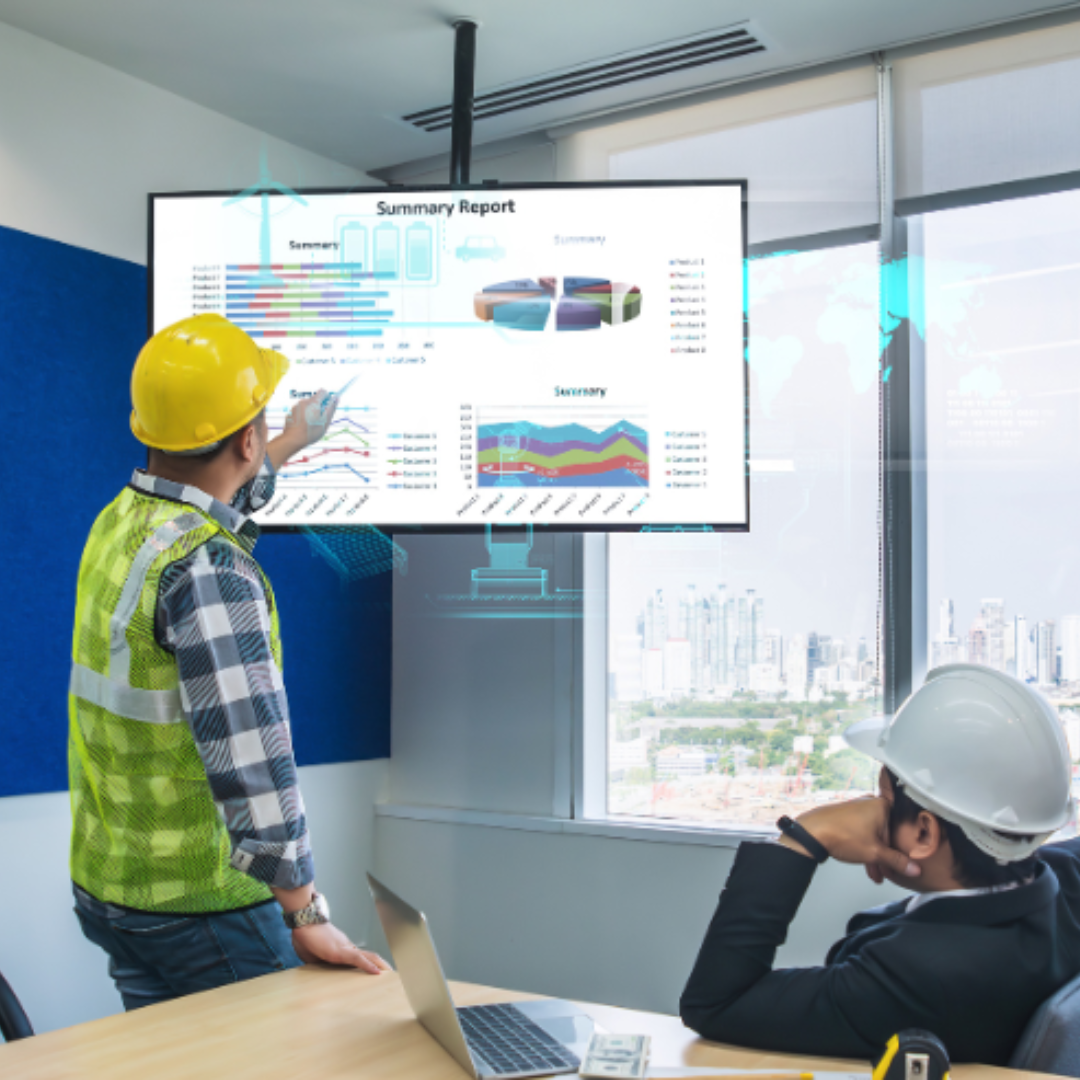 Image showing two construction professionals sitting in an office analysing a project report